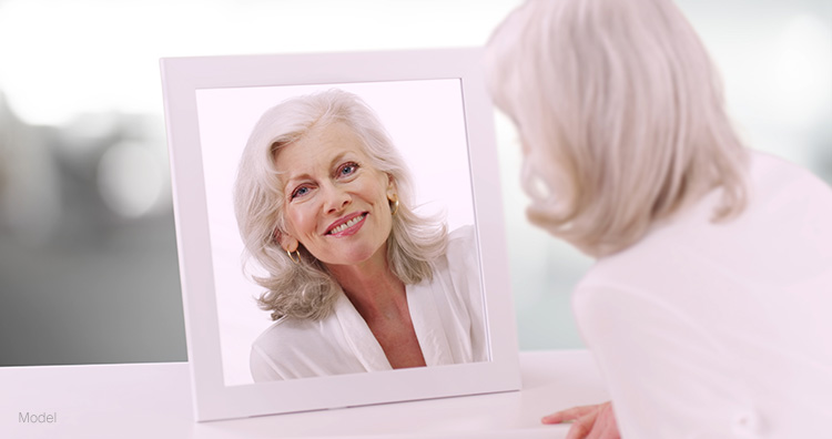 Elderly woman admiring her tight jawline and neck following a La Jolla Lift.