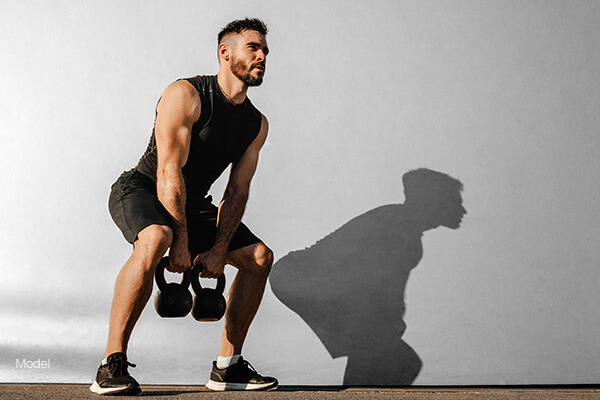 Man workin out with a kettle bell