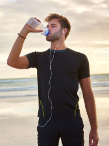 Fit man drinking water